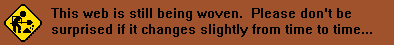 the words 'This web is still being woven. Please don't be suprised if it changes from time to time(dot dot dot)' on a red background. on the left there is a png of a black and yellow street sign of a simple figure shoveling dirt